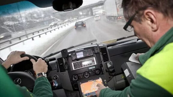 Doi şoferi care au deja instalată sistema în maşină verificînd dacă funcţionează